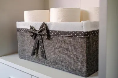 a basket filled with rolled towels with a bow at Apartmaji Pr' Kopavank in Rateče