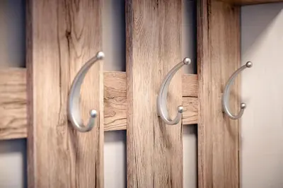 a row of wooden closet doors with metal handles at Apartmaji Pr' Kopavank in Rateče