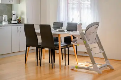 a kitchen with a table with chairs and a treadmill at Apartmaji Pr' Kopavank in Rateče