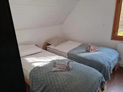 a room with two twin beds with towels on them at Bohinj, Metka - vacation house Pri Metki in Bohinj