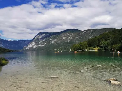 a view of a lake with mountains in the background at Bohinj, Metka - vacation house Pri Metki in Bohinj