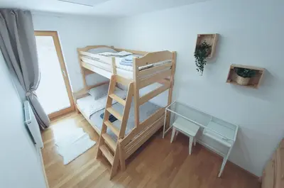 a room with two bunk beds and a mirror at Apartma M&J in Mojstrana