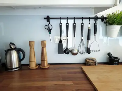 a bunch of kitchen utensils hanging on a wall at Apartma M&J in Mojstrana