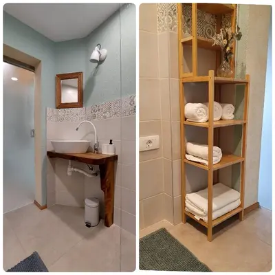 a bathroom with a sink and a shelf with towels at Olivea in Dobrovo