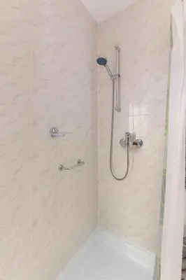 a bathroom with a shower with a shower curtain at Bed and Breakfast Mili Vrh in Kamnik