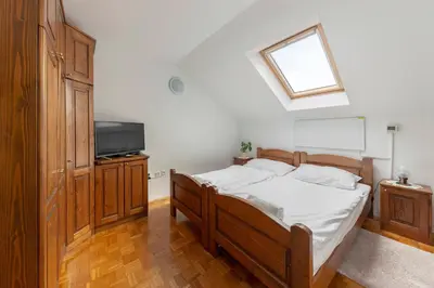 a bedroom with a bed and a television in it at Bed and Breakfast Mili Vrh in Kamnik