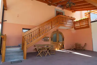 a staircase in a room with a table and chairs at Apartments Masera in Kobarid