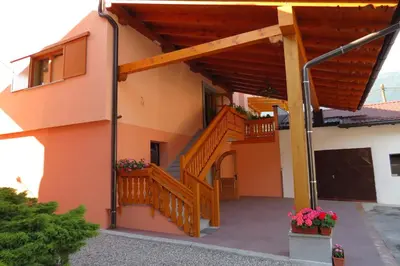 a house with a staircase and a balcony at Apartments Masera in Kobarid