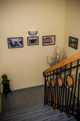 a room with a staircase with pictures on the wall at Apartments Masera in Kobarid