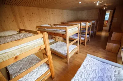 a group of bunk beds in a room at Youth Hostel Punkl in Ravne na Koroškem