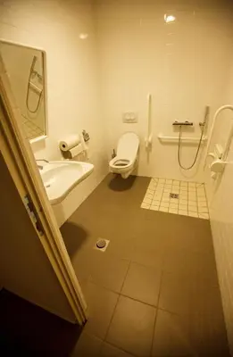 a bathroom with a toilet and a sink at Youth Hostel Punkl in Ravne na Koroškem