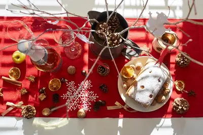 a red table with christmas decorations on it at Apartmaji Koman in Bled