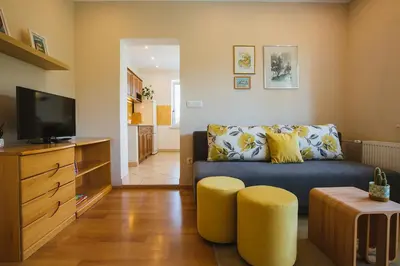 a living room with a couch and a tv at Apartmaji Koman in Bled