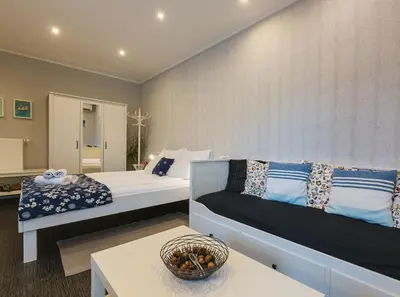 a hotel room with two beds and a table at Apartmaji Koman in Bled