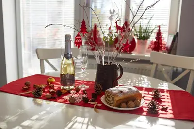 a table with a bottle of wine and a plate of food at Apartmaji Koman in Bled