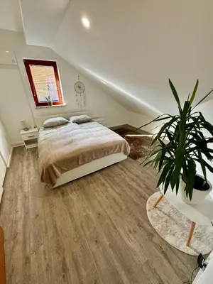a bedroom with a bed and a potted plant at Sunny Oak Estate in Mengeš