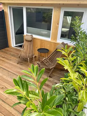 a porch with a bench and a table and some plants at Sunny Oak Estate in Mengeš