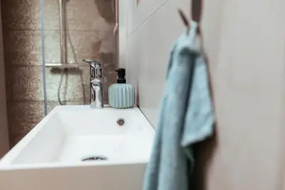 a bathroom sink with a soap dispenser on it at Sunny Oak Estate in Mengeš