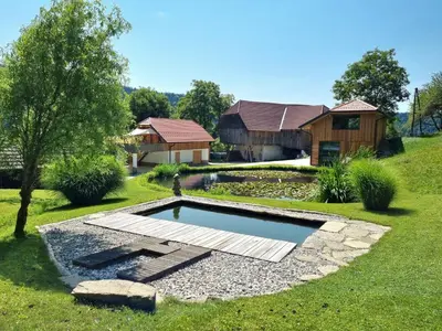 a backyard with a pool and a house at Apartma1 pri Adamu in Mislinja