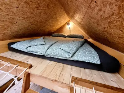 a bed in a small room in a cave at Apartma1 pri Adamu in Mislinja