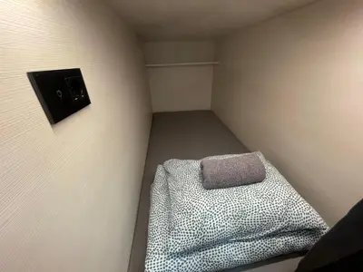 a small room with a pillow on the wall at Sleep&Go Hostel Ljubljana in Ljubljana