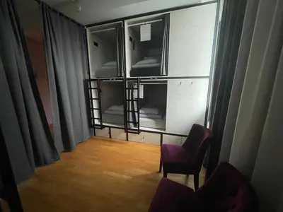 an empty room with two chairs and a window at Sleep&Go Hostel Ljubljana in Ljubljana