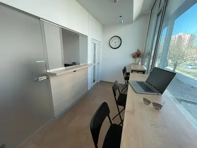 a office with a desk with a laptop on it at Sleep&Go Hostel Ljubljana in Ljubljana