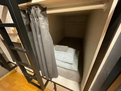 a bunk bed in a room with a ladder at Sleep&Go Hostel Ljubljana in Ljubljana