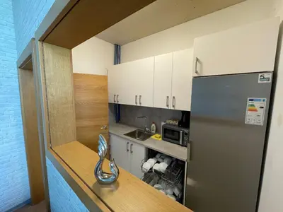 a small kitchen with a stainless steel refrigerator at Sleep&Go Hostel Ljubljana in Ljubljana