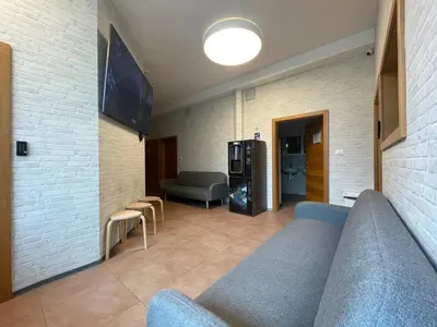 a living room with a couch and a tv at Sleep&Go Hostel Ljubljana in Ljubljana