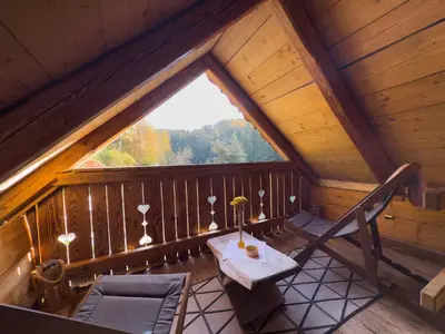 a room with a table and chairs in a attic at Apartma kašča in Domžale