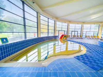 a swimming pool in a building with a swimming pool at Thermal Apartments Lendava in Lendava