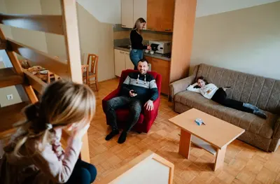 a group of people sitting in a living room at Thermal Apartments Lendava in Lendava