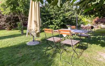 a table and chairs with an umbrella and a table and chairs sidx sidx sidx at Apartma Rozika in Ptuj