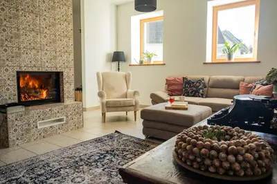 a living room with a couch and a fireplace at Bled House Of Green in Bled