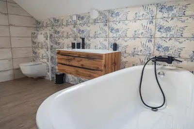 a bathroom with a bath tub and a sink at Bled House Of Green in Bled