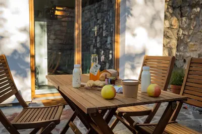a wooden table with two chairs and apples on it at Bled House Of Green in Bled
