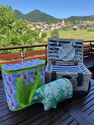 a couple of picnic baskets on a deck at Mountain Vista Apartment in Bled