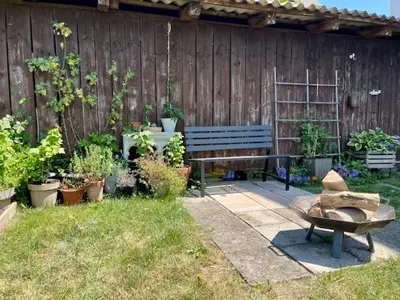 a garden with a bench and a bunch of plants at Mountain Vista Apartment in Bled