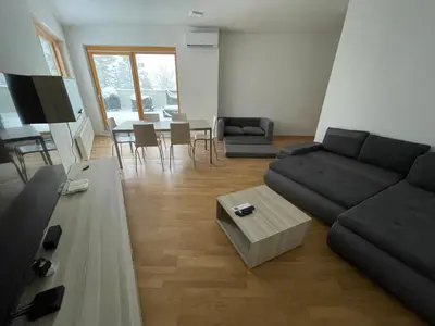 a living room with a couch and a table at Luxury 3-room large Apartment Maribor Pohorje in Pohorje