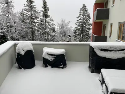 a balcony covered in snow with two chairs at Luxury 3-room large Apartment Maribor Pohorje in Pohorje