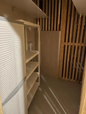 a closet with white shelves and a door at Luxury 3-room large Apartment Maribor Pohorje in Pohorje