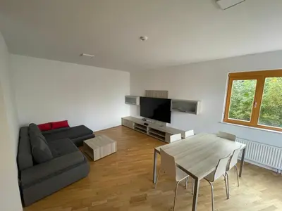 a living room with a couch and a table at Luxury 3-room large Apartment Maribor Pohorje in Pohorje