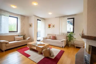 a living room with two couches and a coffee table at JM Alpine Apartments in Kranjska Gora