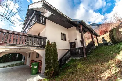 a large house with a balcony and a yard at Holiday Chalet near Bled in Obrne