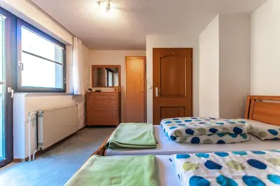 a bedroom with two beds and a window at Holiday Chalet near Bled in Obrne