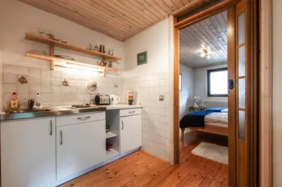 a kitchen with a sink and a bed in a room at Holiday Chalet near Bled in Obrne