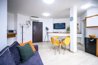 a living room with a couch and a table at The City Loft in Ljubljana
