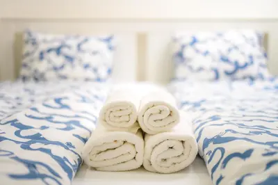 a pile of towels sitting on top of a bed at The City Loft in Ljubljana