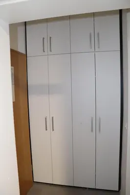 a closet with white cabinets in a room at Studio apartma Terme Ptuj in Ptuj
